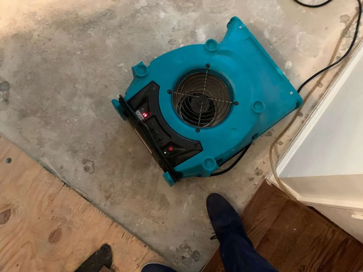 Air mover drying subfloor during Leak Detection & Repair in Highland